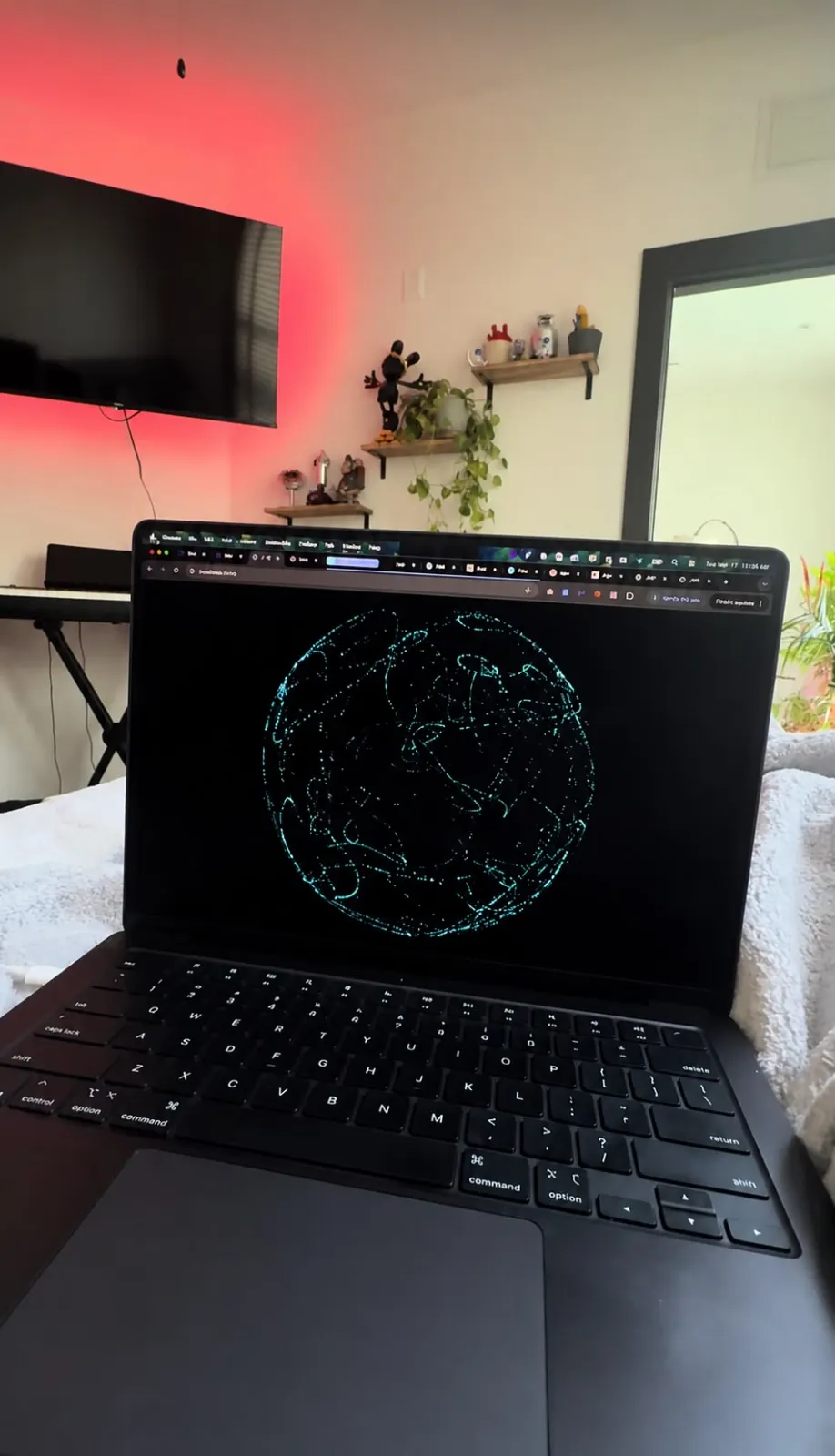 Jarvis AI globe visualization on laptop